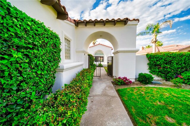 79980 Merion Ln, Quinta, CA 92253 - entrance to property with a tile roof, stucco siding, and a gate