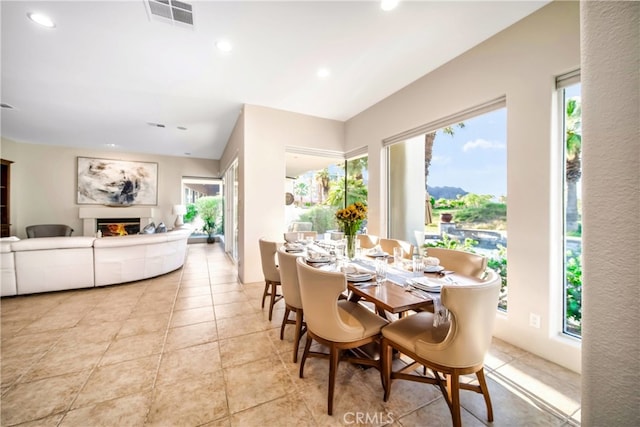 79980 Merion Ln, Quinta, CA 92253 - dining area featuring a glass covered fireplace, recessed lighting, and light tile patterned floors
