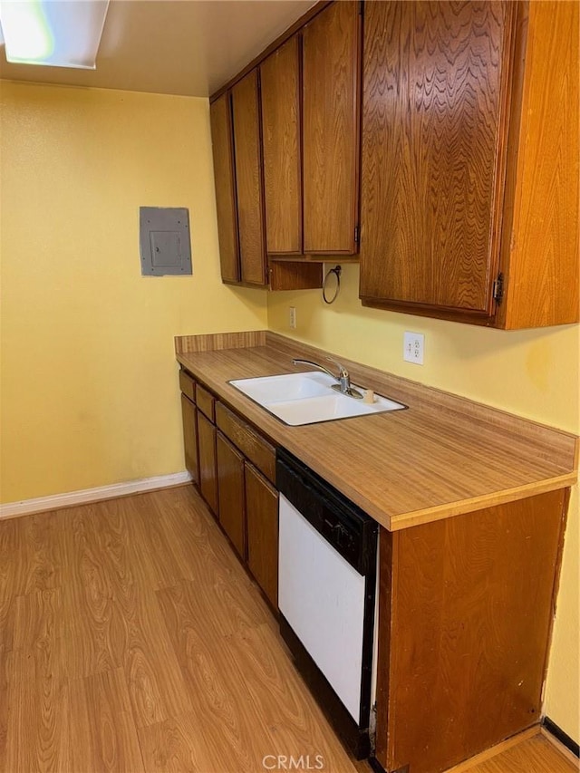 20930 Parthenia St Unit 109, Canoga Park, CA 91304 - kitchen with white dishwasher, a sink, electric panel, and light wood-style floors