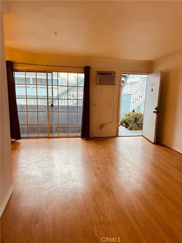 20930 Parthenia St Unit 109, Canoga Park, CA 91304 - empty room with wood finished floors, a wall mounted air conditioner, and baseboards