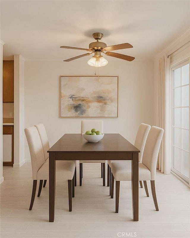 20930 Parthenia St Unit 109, Canoga Park, CA 91304 - dining space featuring ceiling fan, baseboards, and crown molding