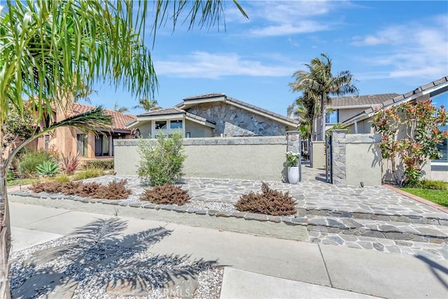 1806 Lake St, Huntington Beach, CA 92648 - view of front facade with a gate, a fenced front yard, stucco siding, and a tile roof