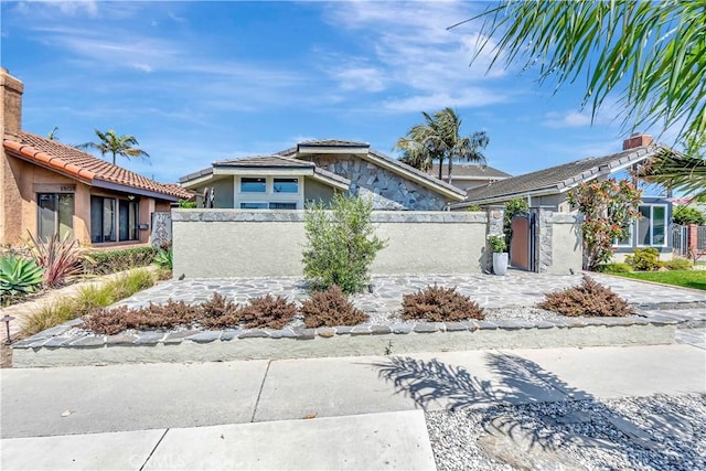 1806 Lake St, Huntington Beach, CA 92648 - view of front of home with a fenced front yard, stucco siding, a tiled roof, a chimney, and a gate