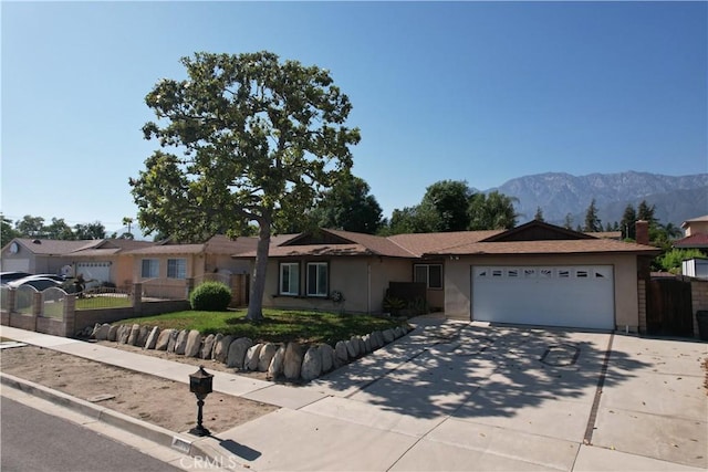 8776 Holly St, Rancho Cucamonga, CA 91701 - ranch-style house featuring an attached garage, driveway, stucco siding, and a mountain view