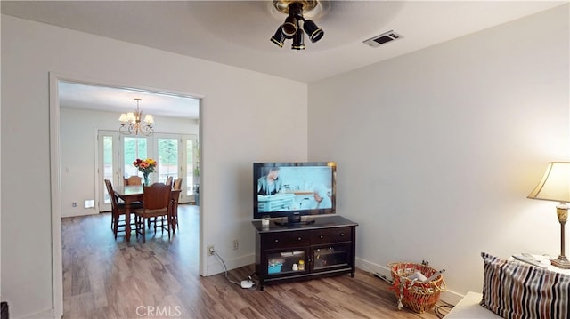 8776 Holly St, Rancho Cucamonga, CA 91701 - living area with wood finished floors, a chandelier, a ceiling fan, and baseboards