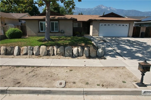 8776 Holly St, Rancho Cucamonga, CA 91701 - single story home with stucco siding, a mountain view, and an attached garage
