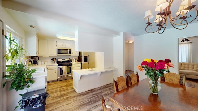 8776 Holly St, Rancho Cucamonga, CA 91701 - dining room featuring light wood-style flooring and a chandelier