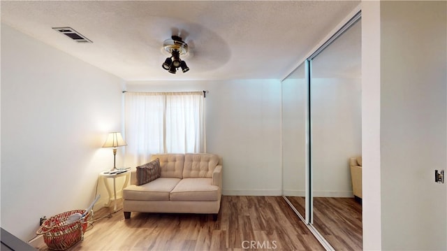 8776 Holly St, Rancho Cucamonga, CA 91701 - living area with wood finished floors, a textured ceiling, baseboards, and a ceiling fan