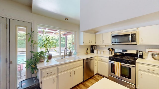 8776 Holly St, Rancho Cucamonga, CA 91701 - kitchen with appliances with stainless steel finishes, a sink, healthy amount of natural light, and light countertops