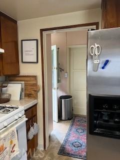2415 Cabrillo Ave, Torrance, CA 90501 - kitchen featuring stainless steel fridge, white gas range, and light countertops