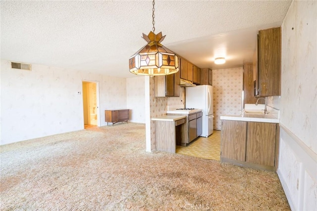 2468 Mohawk St Unit 102, Pasadena, CA 91107 - kitchen with wallpapered walls, light countertops, brown cabinets, a textured ceiling, and a sink