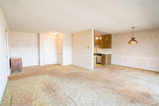 2468 Mohawk St Unit 102, Pasadena, CA 91107 - unfurnished living room featuring wallpapered walls, light colored carpet, and a textured ceiling