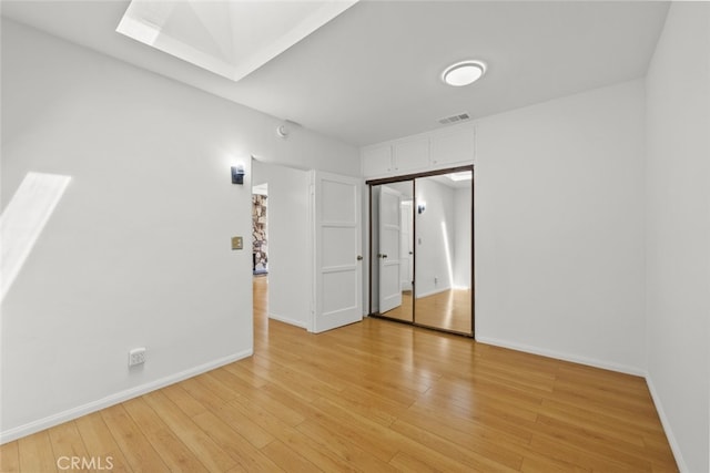 6031 Beck Ave, North Hollywood, CA 91606 - unfurnished bedroom featuring a skylight, light wood-style floors, baseboards, and a closet