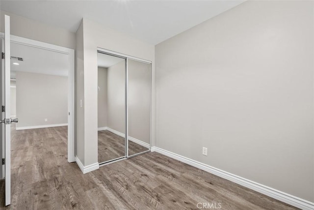 13339 Bonanza St, Arleta, CA 91331 - unfurnished bedroom with wood finished floors, a closet, and baseboards