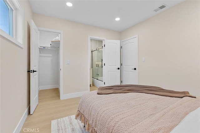 11091 Ranger Dr, Los Alamitos, CA 90720 - bedroom featuring baseboards, light wood finished floors, a walk in closet, recessed lighting, and a closet