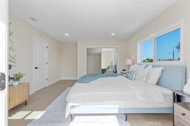 11091 Ranger Dr, Los Alamitos, CA 90720 - bedroom with light wood-style floors, a closet, baseboards, and recessed lighting