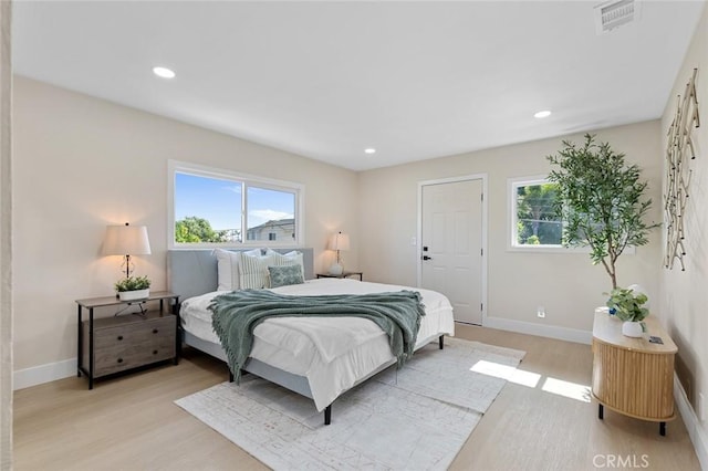 11091 Ranger Dr, Los Alamitos, CA 90720 - bedroom with multiple windows, light wood-style floors, baseboards, and recessed lighting