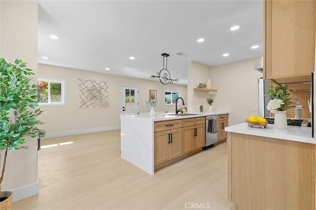 11091 Ranger Dr, Los Alamitos, CA 90720 - kitchen with stainless steel dishwasher, light wood-style flooring, a sink, light countertops, and recessed lighting