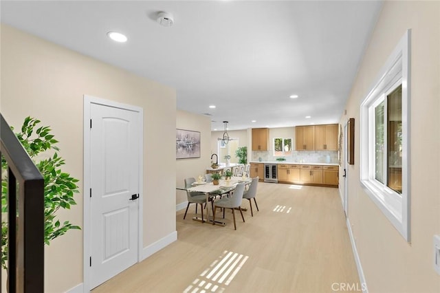 11091 Ranger Dr, Los Alamitos, CA 90720 - dining area with beverage cooler, baseboards, recessed lighting, and light wood-style floors