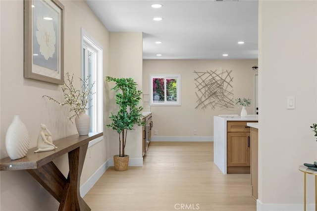 11091 Ranger Dr, Los Alamitos, CA 90720 - hallway with light wood-type flooring, baseboards, and recessed lighting
