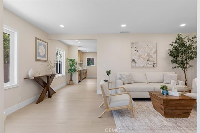 11091 Ranger Dr, Los Alamitos, CA 90720 - living room featuring light wood-style flooring, recessed lighting, and baseboards