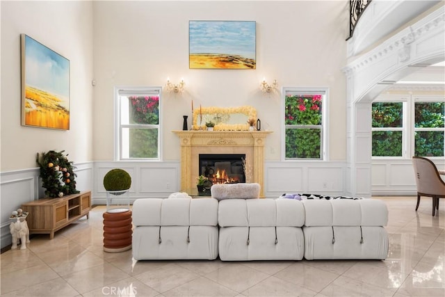 553 Woodward Blvd, Pasadena, CA 91107 - living area featuring a decorative wall, a glass covered fireplace, a high ceiling, and a wainscoted wall