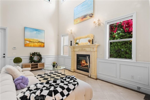 553 Woodward Blvd, Pasadena, CA 91107 - living room with healthy amount of natural light, tile patterned flooring, a decorative wall, a towering ceiling, and a glass covered fireplace