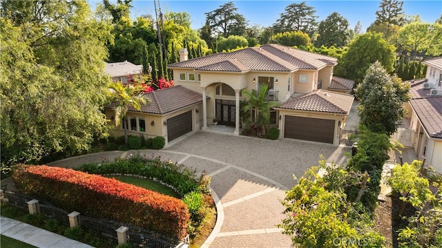 553 Woodward Blvd, Pasadena, CA 91107 - mediterranean / spanish home featuring an attached garage, driveway, a tile roof, a chimney, and stucco siding