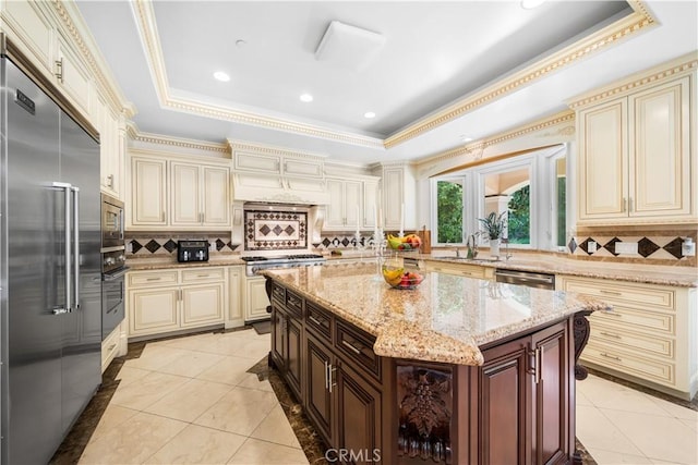 553 Woodward Blvd, Pasadena, CA 91107 - kitchen with cream cabinetry, built in appliances, a raised ceiling, backsplash, and crown molding