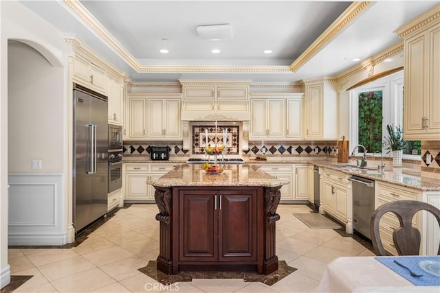553 Woodward Blvd, Pasadena, CA 91107 - kitchen with cream cabinets, built in appliances, a sink, light stone countertops, and crown molding
