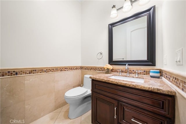 553 Woodward Blvd, Pasadena, CA 91107 - bathroom with tile walls, toilet, vanity, tile patterned flooring, and wainscoting