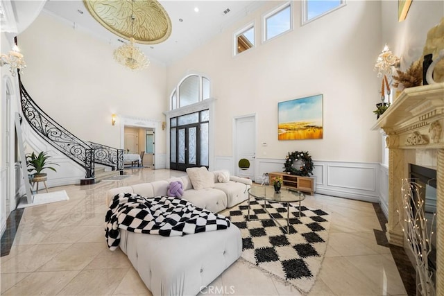 553 Woodward Blvd, Pasadena, CA 91107 - living area featuring a towering ceiling, a decorative wall, a high end fireplace, stairway, and wainscoting