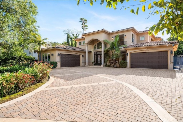 553 Woodward Blvd, Pasadena, CA 91107 - mediterranean / spanish-style home with a garage, stucco siding, decorative driveway, and a tile roof