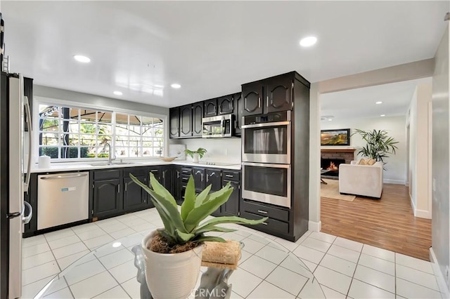 24851 Via Santa Cruz, Mission Viejo, CA 92692 - kitchen with appliances with stainless steel finishes, a sink, light countertops, light tile patterned flooring, and recessed lighting