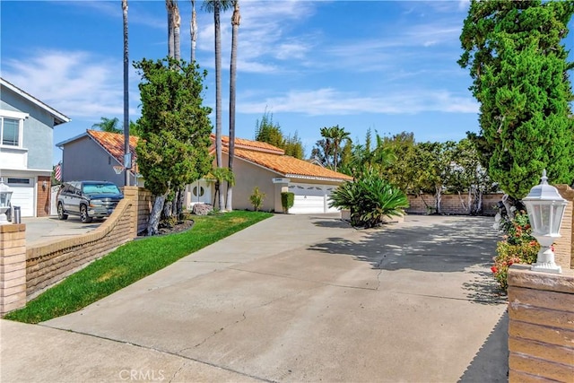 24851 Via Santa Cruz, Mission Viejo, CA 92692 - view of front facade featuring stucco siding, a garage, driveway, and a tile roof