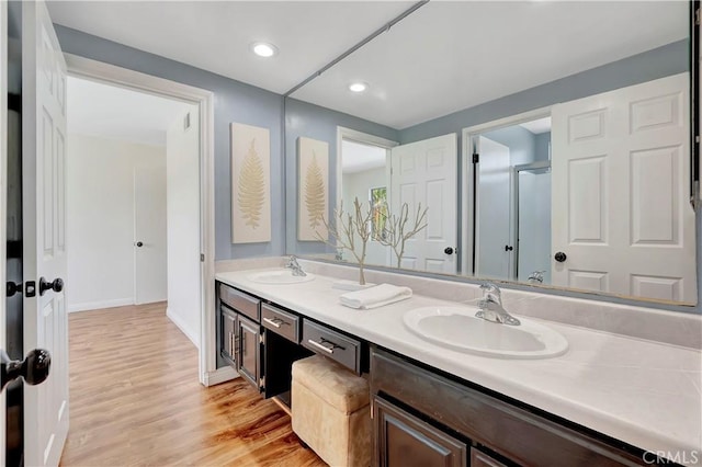 24851 Via Santa Cruz, Mission Viejo, CA 92692 - bathroom featuring double vanity, wood finished floors, recessed lighting, and baseboards