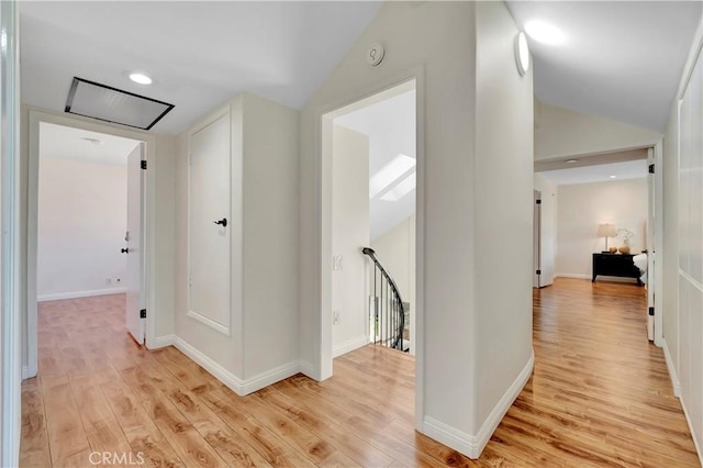24851 Via Santa Cruz, Mission Viejo, CA 92692 - hall featuring an upstairs landing, light wood-style flooring, lofted ceiling, and baseboards