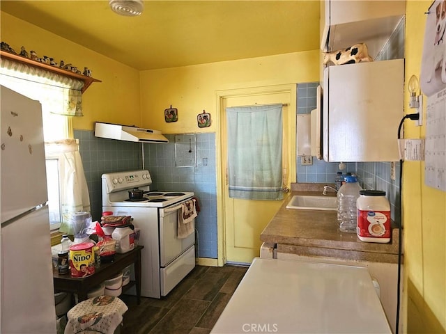 415 E Florinda St, Hanford, CA 93230 - kitchen featuring white appliances, under cabinet range hood, a sink, tile walls, and backsplash
