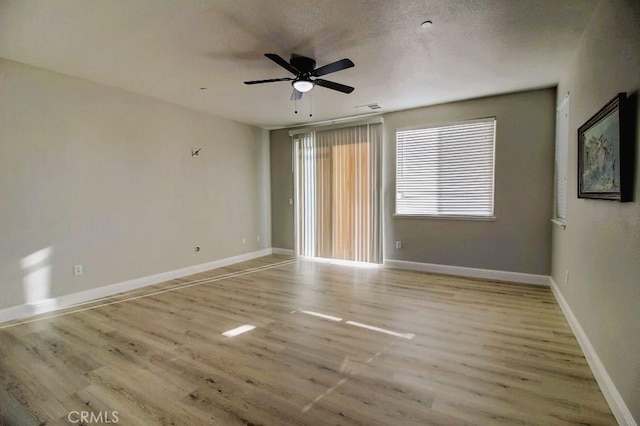 691 Pinot Blanc Ct, Los Banos, CA 93635 - spare room featuring light wood-style floors, a ceiling fan, and baseboards