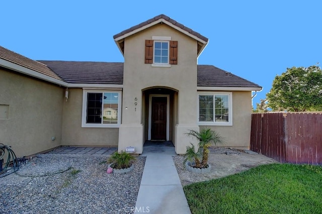 691 Pinot Blanc Ct, Los Banos, CA 93635 - view of front facade featuring stucco siding, a patio area, and a tile roof