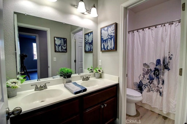 691 Pinot Blanc Ct, Los Banos, CA 93635 - full bath with toilet, double vanity, wood finished floors, and curtained shower