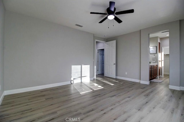 691 Pinot Blanc Ct, Los Banos, CA 93635 - unfurnished bedroom featuring wood finished floors, baseboards, ceiling fan, and connected bathroom