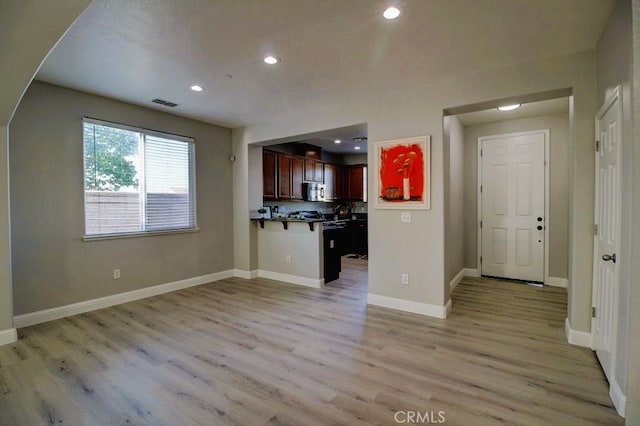 691 Pinot Blanc Ct, Los Banos, CA 93635 - unfurnished living room featuring recessed lighting, light wood-type flooring, and baseboards