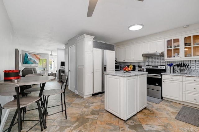 264 Espanas Gln, Escondido, CA 92026 - kitchen with electric range, paneled fridge, under cabinet range hood, light stone finish flooring, and ceiling fan
