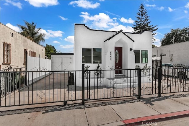 3140 Pluma St, Lynwood, CA 90262 - view of front of house featuring stucco siding, a gate, and a fenced front yard