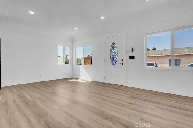 3140 Pluma St, Lynwood, CA 90262 - entryway with recessed lighting, light wood-type flooring, and a textured ceiling