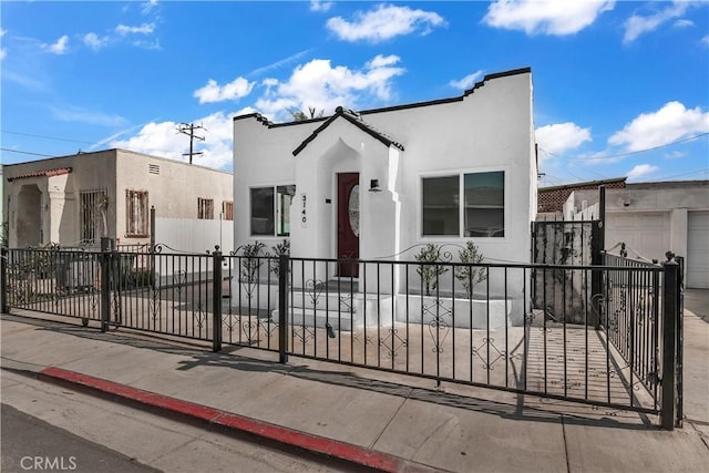 3140 Pluma St, Lynwood, CA 90262 - mediterranean / spanish-style home with stucco siding, a fenced front yard, and a garage