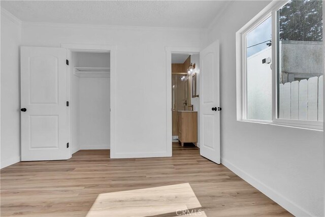 3140 Pluma St, Lynwood, CA 90262 - unfurnished bedroom with light wood-style floors, ornamental molding, ensuite bathroom, and a closet