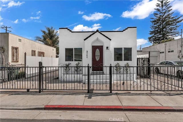 3140 Pluma St, Lynwood, CA 90262 - mediterranean / spanish-style home featuring stucco siding, a fenced front yard, and a gate