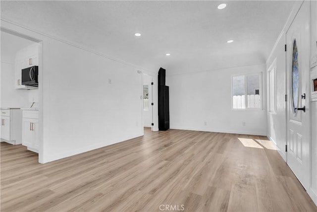 3140 Pluma St, Lynwood, CA 90262 - unfurnished living room featuring light wood-style floors and recessed lighting